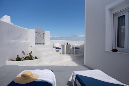 VourvoúlosWhite Swallow Suite Santorini的客房享有海滩和白色建筑的景致。