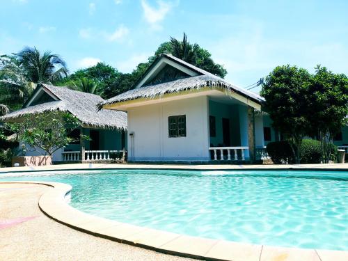 小通奈潘Phuwadee Resort的房子前面的房子和游泳池