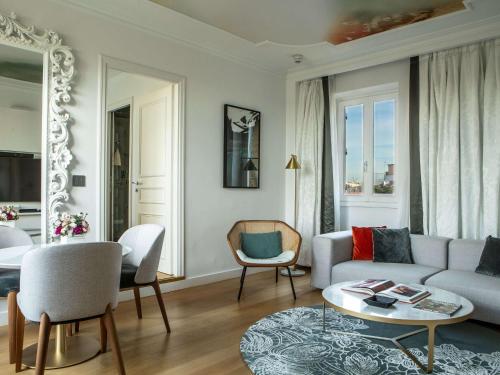 罗马Sofitel Roma Villa Borghese的客厅配有沙发和桌子