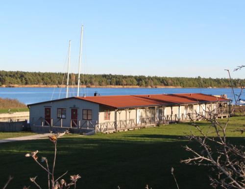 VallevikenValleviken Hotell的一座大型建筑,后面有湖泊
