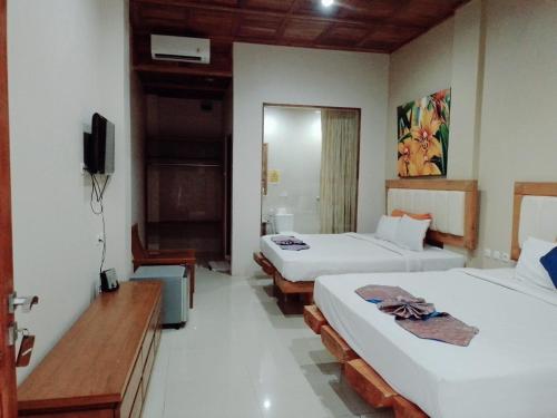 水晶海滩巴厘酒店客房内的一张或多张床位
