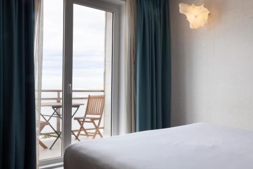 格乔多摩升佩蒂特宫酒店的一间卧室配有一张床,阳台配有桌子
