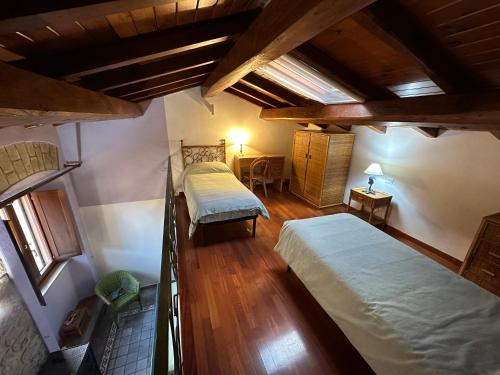 泰拉奇纳Casa Rappini的阁楼卧室配有两张床和一张桌子