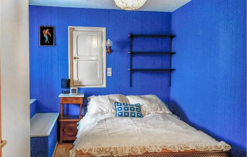 PfaffenheimAwesome Home In Pfaffenheim With 2 Bedrooms的蓝色的卧室,配有床和蓝色的墙壁