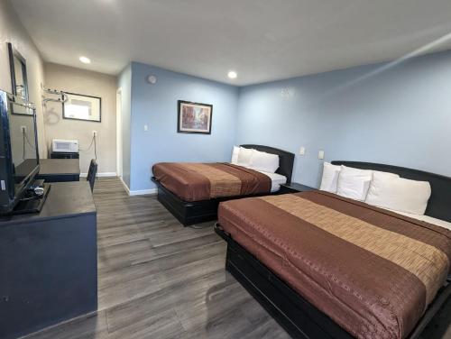 巴斯托BEST MOTEL的酒店客房设有两张床和一台平面电视。