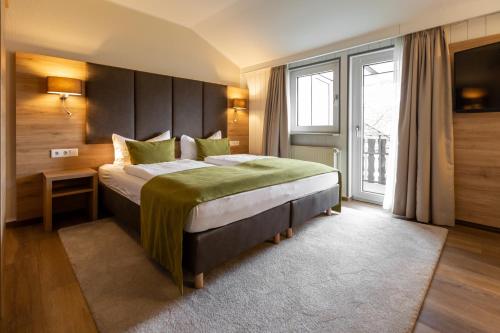 乌斯拉尔浪漫之旅酒店的一间卧室设有一张大床和一个大窗户