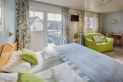 Gottenheim皇冠餐厅旅馆的卧室配有床、椅子和窗户。