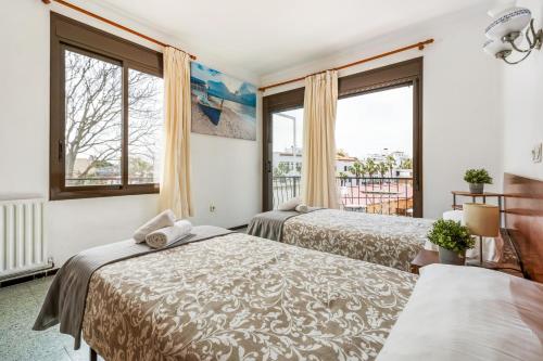 普拉加德阿罗Hostal La Marina的带2扇窗户的客房内的2张床