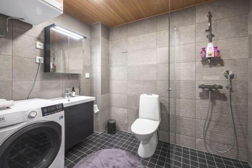 库奥皮奥Ydinkeskustassa saunallinen loft huoneisto的一间带洗衣机和卫生间的浴室