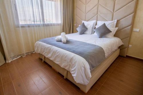 马拉喀什Appartement luxueux Coralia avec piscine的床上坐着一只塞满食物的动物