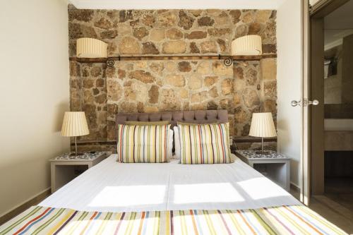 安塔利亚Glamorous Flat with Jacuzzi near Hadrians Gate的一间卧室配有一张大床和两盏灯