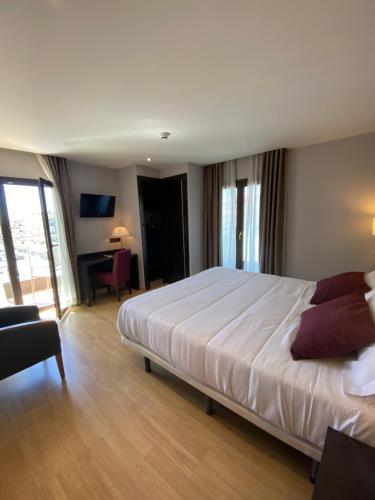 布拉内斯珀蒂帕劳酒店 - 仅限成年人的一间卧室配有一张大床和一张书桌