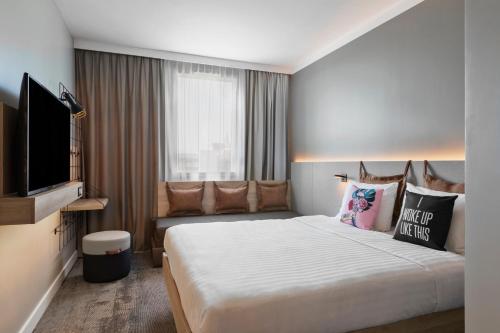 亚眠亚眠中心卡帕尼尔 - 吉尔卡萨达拉酒店的配有一张床和一台平面电视的酒店客房