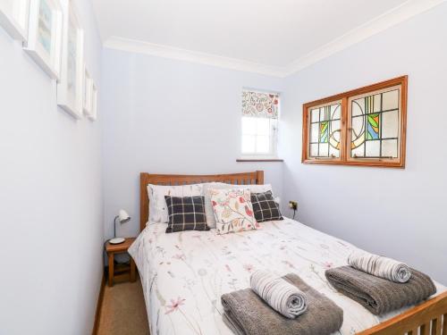 诺里奇Hunters Lodge的卧室配有带枕头的床铺和窗户。