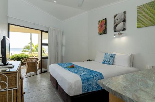 拉罗汤加Club Raro Resort- Adults Only的一间卧室配有一张床,享有海景