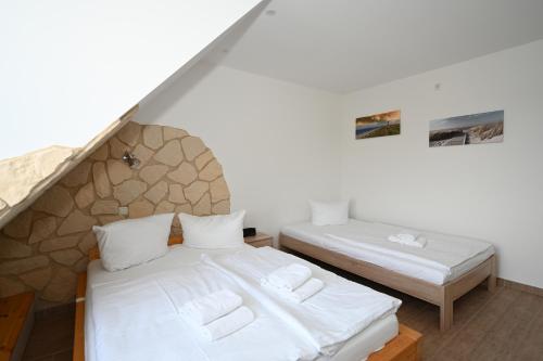 乌埃克尔明德Lagunenstadt Ueckermünde AG的配有白色床单的客房内的两张床