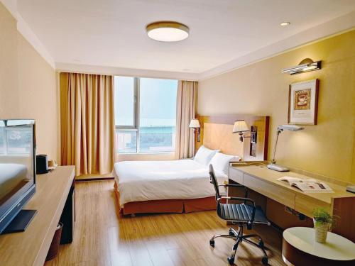 芦竹甲桂林商务旅馆的配有一张床和一张书桌的酒店客房