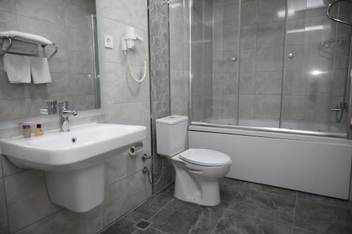安卡拉Cihan Palas的浴室配有盥洗盆、卫生间和浴缸。