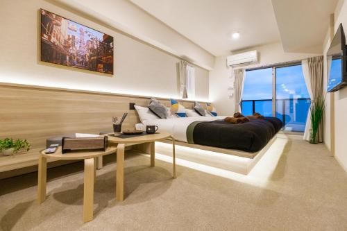 大阪Apartment Hotel 11 Kuromon的一间卧室配有一张大床和一张桌子