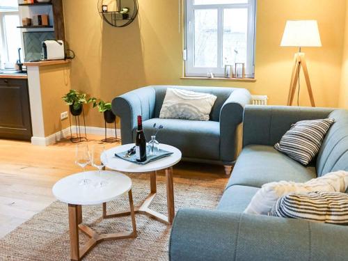 施马伦贝格Ferienhaus Altstadtchalet的客厅配有蓝色的沙发和2张桌子
