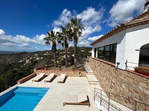 Castillo de AroVilla with seaview at Platja d'Aro 11p的一座别墅,设有游泳池和棕榈树