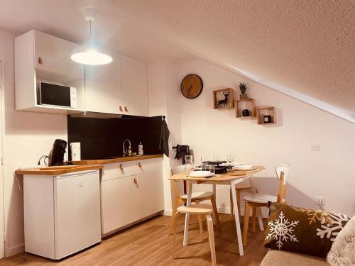布齐耶比利牛斯2000Le pti ‘ P2000的一间带桌子的厨房和一间带用餐室的小厨房