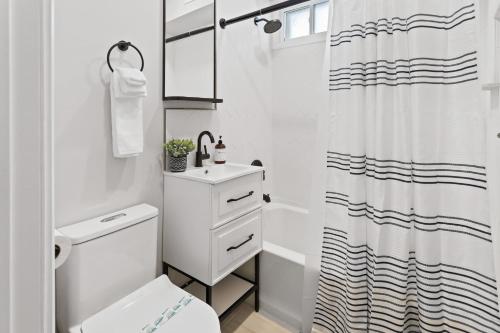 大西洋城Loopin Around Atlantic City Luxe 5BR Townhouse in Orange Loop的白色的浴室设有卫生间和淋浴。