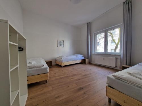 杜伊斯堡RAJ Living - 2 , 3 and 4 Room Apartments - 25 Min Messe DUS的客房设有两张床和窗户。