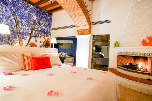 库埃纳瓦卡Anticavilla Hotel Restaurante & Spa的卧室配有1张白色床和壁炉