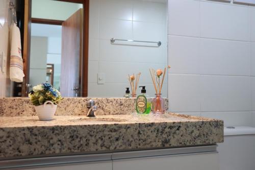 马塞约Maceio Ferias apto com varanda vista mar的浴室的柜台设有水槽和镜子