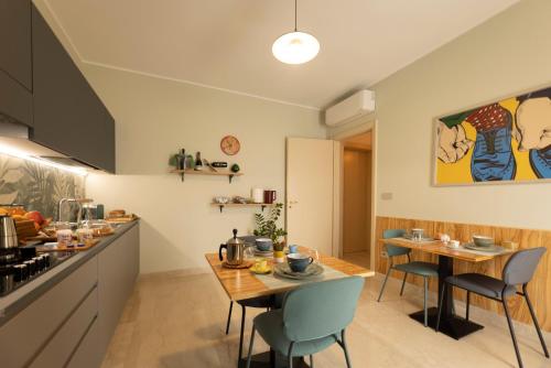 加利亚诺德尔卡波Dimora Lauro的一间厨房和带两张桌子及椅子的用餐室