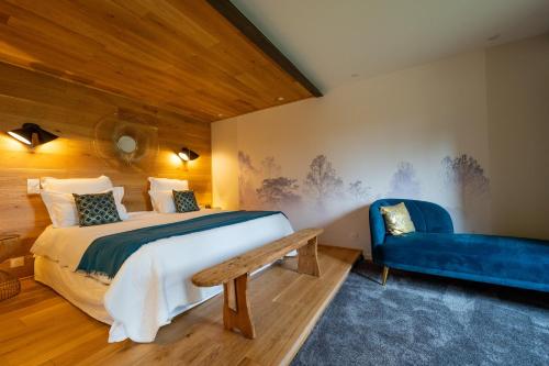 巴尼奥勒Songes de vigne的一间卧室配有一张床和一张蓝色的沙发