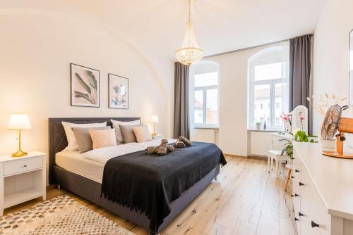 梅森Fynbos Apartments Theaterblick, Netflix, Parkplatz的一间卧室设有一张大床和两个窗户。