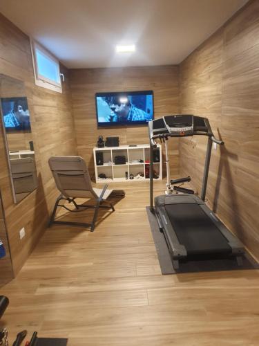 格拉韦洛纳托切Villa Mariel Lago Maggiore luxury Suite & Wellness的健身房设有跑步机,房间设有电视