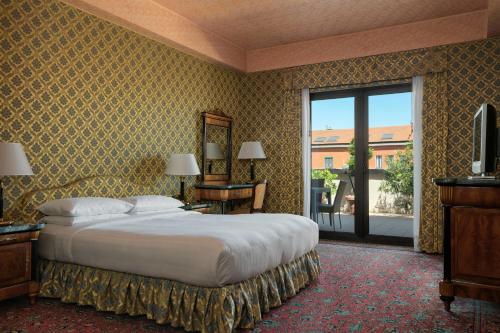 米兰米兰万豪酒店的一间卧室设有一张大床和一个大窗户