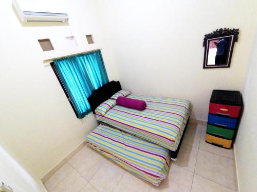 DemanganKotagede Street Homestay Jogja的窗户房间里带条纹沙发