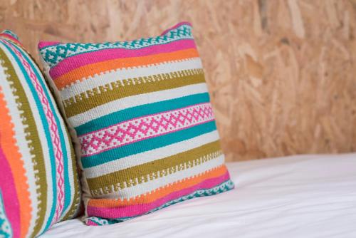 波尔图Fred's House Asprela的床上配有两个色彩缤纷的枕头