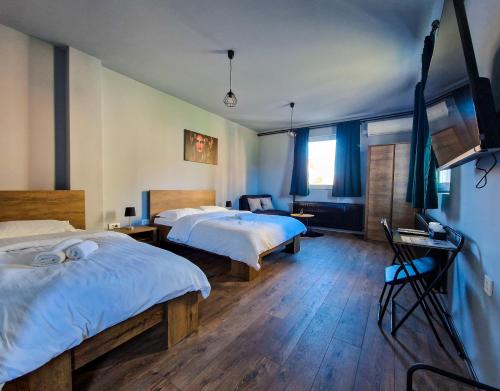 奥西耶克XXL rooms&spa的配有蓝色墙壁和木地板的客房中的两张床
