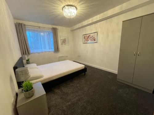 威根Moda Wigan 2 - Stylish 2 Bed in Central Wigan的一间卧室设有一张大床和一个窗户。