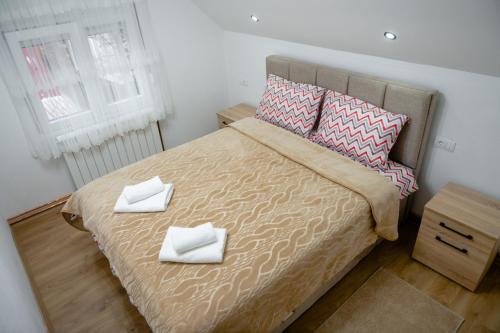 科拉欣Golden House的一间卧室配有一张带两条白色毛巾的床