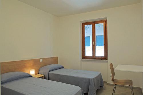 坎普码头卡萨皮内塔公寓酒店的一间医院间,设有两张床和窗户