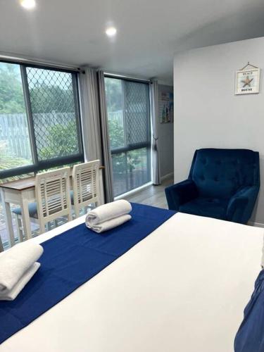 UranganSnapper Villa - Seaside的一间卧室配有一张床、一把椅子和窗户。