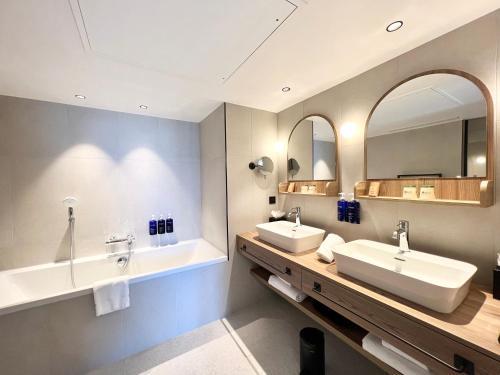迪纳尔Emeria Dinard Thalasso Spa - Avril 2024 Réouverture après rénovation的浴室设有2个水槽和2面镜子