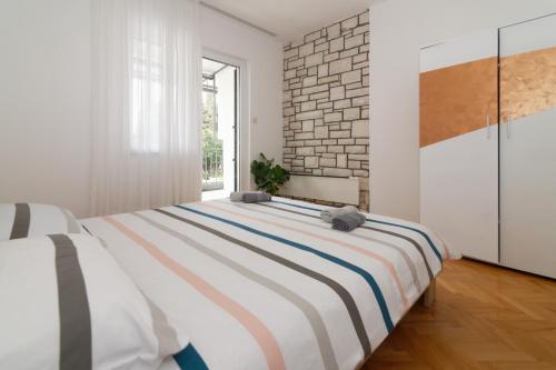 诺维格勒伊斯特拉Apartments Jasna 3的一间卧室设有一张大床和砖墙