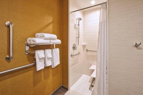 普拉茨堡Fairfield Inn & Suites by Marriott Plattsburgh的带淋浴、卫生间和毛巾的浴室