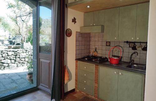 PuntalazzoVilla Alessio - Case Vacanza con Piscina sull'Etna的厨房配有水槽和炉灶