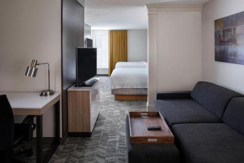 新奥尔良SpringHill Suites by Marriott New Orleans Warehouse Arts District的客厅配有沙发和1张床