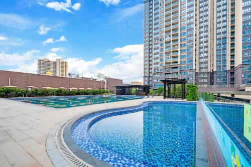 惠州惠州裕华铂金酒店的一座位于城市的游泳池,有高大的建筑