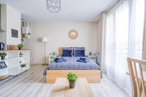 CourcouronnesLogement Noah的一间卧室配有一张带蓝色枕头的大床
