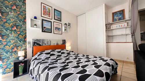 鲁西隆地区卡内LE COSY Canet - Studio 2 personnes à 30m de la plage, wifi fibre clim netflix的卧室配有黑白床。